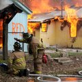 Members of the Rogers Fire Department participate in a training burn Monday on North B Street in Rog...
