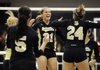 Bentonville’s Kelsey Parks, center, celebrates a kill with her teammates during the Lady Tigers’ match Tuesday against Siloam Springs in Bentonville.