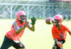  Senior Terrell Williams attempts to catch a pass with Kristen Crite, a sophomore, defending. 
