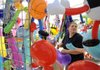 Tabatha Lack of Rowlett, Texas, stocks the Ducky Derby tent with inflatible toys Friday, Aug. 26, 2011, while working with her aunt, Cheryl Corby, not pictured, to get set up for the opening of the 27th annual Frisco Festival in downtown Rogers. The festvial continues today with a pancake breakfast at 6:30 a.m. and runs through 10 p.m. For a full schedule of events go to friscofestival.com.
