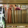 Proper order Librarian Leasa Wood organizes books Tuesday morning in the young adults section of the...