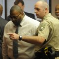 Jarrod Hankins, right, bailiff in Judge William Storey’s court, escorts JoeMo Kenyarty Graham out of...