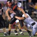 Magazine quarterback Ryan Chambers tries to shake West Fork defender Wil Jarnagan during Tuesday nig...