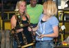Staff photo by Samantha Baker.
Jennifer Emerson, left, hands Katie Tunstill, 16, the trophy for Grand Steer Champion Friday, Sept. 2, 2011, at the Washington County Fair in Fayetteville. Tunstill has been showing livestock for 11 years and has accumulated wins in five county fairs in addition to championships at the state and district level.
