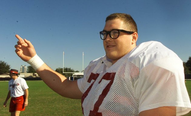 in-this-file-photo-taken-dec-29-1998-arkansas-brandon-burlsworth-tells-a-story-to-teammates-before-the-beginning-of-practice-at-thunder-field-near-the-citrus-bowl-in-orlando