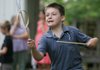 Eli Denham, 8, of Fayetteville plays graces at the Shiloh Museum in Springdale. The game was created to teach agility, poise and grace to children in the 18th century. 