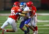 #11 William Daniel of Bryant gets sandwiched by #25 Gabe Sopeshire and #2 Jermaine Pryer of Northside.