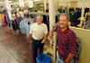 Bruce Parker, right, and his brother, Brent, own the Dollar Saver in downtown Rogers. The Parkers have owned the business for more than 30 years and the business has been operating for more than 40.
