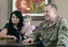 INSTANT COMMUNICATION Army Lt. Col. Tim Williams talks about his time overseas while with his wife, Sheryl Williams, and his granddaughter, Mabry Kordsmeier, 17 months, listen. While in Afghanistan he read an Angelina Ballerina tale to Mabry while his family in Northwest Arkansas followed on their computer screen. Skype technology allowed Williams and his family to hear and see one another from half a world apart.
