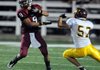 Springdale senior Henry Hernandez pushes off Lake Hamilton junior Zack Sandlin in the first half on Friday at Jarrell Williams Bulldog Stadium in Springdale.