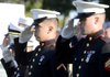 Marines salute the United States Flag on Sunday, Sept. 11, 2011, during a ceremony following the Walmart NW Arkansas Championship at Pinnacle Country Club in Rogers. Members of the armed forces, police and firefighters were honored during a ceremony following the tournament. 