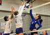 Rogers High School’s Emily Osborne attempts to hit the ball past Shannon Airola and Taylor Hightower of Fayetteville High School on Tuesday in Rogers. Fayetteville won the match in a clean sweep of sets, 3-0.