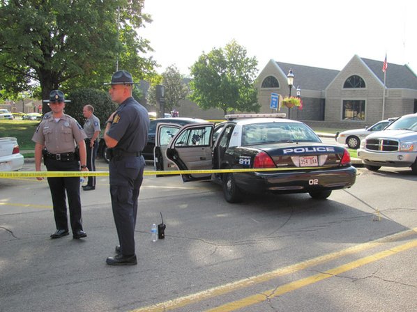 Law enforcement personnel stand Tuesday ...