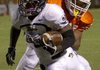 Bentonville running back Tearris Wallace fights for yards Friday in the Tigers' 36-0 win over Texas High School in Texarkana. 