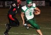 STAFF PHOTO DAVID FRANK DEMPSEY - Greenland quarterback Darian Froud, right, runs a keeper pursued by Blackhawk defender Dalton Morgan in Pea Ridge, Ark. Friday, Sept 16, 2011.
