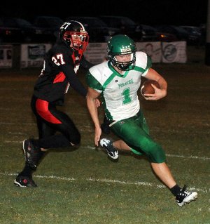 STAFF PHOTO DAVID FRANK DEMPSEY - Greenland quarterback Darian Froud, right, runs a keeper pursued by Blackhawk defender Dalton Morgan in Pea Ridge, Ark. Friday, Sept 16, 2011.