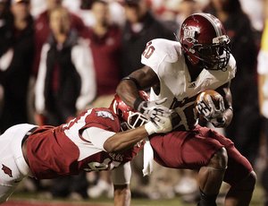 Troy receiver Shawn Southward avoids a tackle by Arkansas’ Alonzo Highsmith during Saturday’s game. Southward had two catches for 27 yards, contributing to the Trojans’ 373 yards in the air. Troy scored three touchdowns on pass plays. 