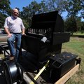 Ron Autry, volunteer coordinator for the barbecue portion of Bikes, Blues & BBQ, shows off a barbecu...