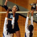 Katie Hugg of Springdale Har-Ber spikes the ball as Rogers Natalie Gutierrez, left, and Katie Peders...