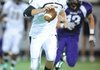 Bentonville senior quarterback Dallas Hardison, center, looks for room to run through the Fayetteville defense Friday, Sept. 23, 2011, during the first half of play at Harmon Field. Go to photos.nwaonline.com to see more photos.