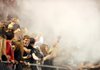 TIGER TALC FOG Bentonville High School students laugh as they send handfuls of talc into the air Friday as the Tigers’ football team takes the field to play the Fayetteville High School Bulldogs at Harmon Field in Fayetteville. Bentonville won the game, 41-6. For a report on the game, turn to sports, 6A.
