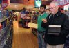 Bob Blalock, a salesman for Glazers Wholesale Liquor and Wine, right, confirms with Nick Lerud, Macadoodles assistant manager, which types of vodka need to be ordered Thursday at the Springdale store. As many as six new permits for liquor stores may be available in Springdale, but because state laws prohibit another franchise being open under the Macadoodles name, it is likely the chain will not pursue another permit.
