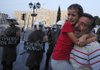 A father and his daughter react during an anti-austerity protest Sunday in front of the Greek parliament. A discussion among German lawmakers about new rescue-fund powers is taking place this week amid worries that Greece ultimately will be unable to pay its debts. 