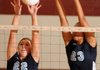 Springdale Har-Ber’s Emily Coats, left, and Summer Morgan block a shot from Springdale High last Thursday. Coats, a sophomore, is making a major impact for the Lady Wildcats in her first season on the varsity team.