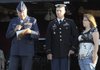 IN RECOGNITION Army Specialist Nicholas Harvey, center, stands on stage Thursday, with his wife, Brianne Harvey, right, while Air Force Lt. Col. Steve Gray presents him with the Purple Heart during the opening ceremony of the Lowell Bike Rally at Ward Nail Park. Harvey was injured by an improvised explosive device while serving with the 370th Sapper Company of the 54th Engineer Battalion.
