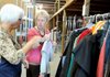 Mary Primm, left, and Norma Curl sort through clothes in the Compassion Center stock room on Thursday. The center will be run largely by volunteers.
