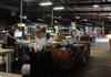 Jeremy Fretueg, left, and Austin Gann work on shipments Wednesday at Acumen Brands’ warehouse in Fayetteville. The company recently moved from a 15,000-square-foot workspace to a 60,000-square-foot building in a former Coca-Cola bottling plant.

