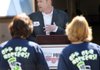 Sherri Napier, left, and Sandra Gibson, both Fayetteville Senior Activity and Wellness Center members, listen Wednesday at Fire Station No. 1 in Fayetteville as Justin Tennant, Fayetteville City Council alderman for Ward 3, speaks to supporters of the 1 percent sales tax initiative that will go to a vote Oct. 11.
