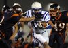 Rogers running back Diego Rojas, center, is chased down by Rogers Heritage defensive back Daniel Spickes, left, and Jonathan James on a first down carry during the Mounties’ game Friday against the War Eagles at Gates Stadium in Rogers.
