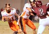 Gravette senior Tyler Greenhaw runs the ball downfield while his teammate Dallas Kerley blocks Gentry defender Nelson Watson during play on Friday.