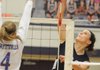 Springdale Har-Ber’s Katie Huff attempts a spike against a Fayetteville defender on Tuesday in Bulldog Gymnasium in Fayetteville. Fayetteville won in three straight sets.