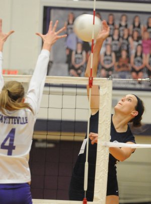 Springdale Har-Ber’s Katie Huff attempts a spike against a Fayetteville defender on Tuesday in Bulldog Gymnasium in Fayetteville. Fayetteville won in three straight sets.