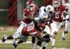 Auburn running back Onterio McCalebb (23) is stopped by Arkansas safety Jerico Nelson (31), safety Tramain Thomas (5), and cornerback Tevin Mitchel (8) during the first half of the NCAA college football game in Fayetteville, Ark., Saturday, Oct. 8, 2011.