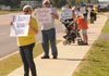 Stella Wadley, from left, and her husband, Wayne Wadley, stand with a group of pro-life advocates in front of the Word of Life Fellowship Church in Bentonville on Oct. 2. The demonstration was part of the national Life Chain right to life event.
