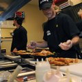 ZAXBY’S OPENS Chris Pairscoff finishes salads for customers at the drive-through Wednesday during th...