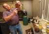 Ron Cox, assistant farm manager for the University of Arkansas, explains part of the process that his facility uses to produce biodiesel for use on the farm from waste cooking oil from the university’s food preparation operation at the university farm in Fayetteville.
