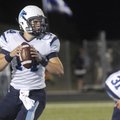 Har-Ber High’s Jon Vaughn looks for a receiver Friday while taking on Rogers High School in Rogers....