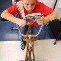 Mason Lockman pedals a stationary bicycle while he reads at Russell D. Jones Elementary School in Ro...