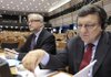 European Commission President Jose Manuel Barroso, right, and European Commissioner for Economic and Monetary Affairs Olli Rehn attend the parliamentary session at the European Parliament in Brussels. Barroso warned Wednesday that banks should have to meet new capital standards before awarding dividends or bonuses.