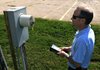 Matt Fincher, a Bentonville meter reader, keys in the electrical usage reading Wednesday for a property at 301 N. Walton Blvd. in Bentonville. The city is interested in changing the way they collect both water and electrical usage by phasing in an automated meter reading system.