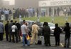 Job seekers line up outside the Crown Exposition Center in Fayetteville, N.C., for a job fair Wednesday. The number of people applying for unemployment benefits fell slightly last week. 