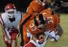 STAFF PHOTO J.S. WEDGEWORTH -- Gravette's Darrick Strzelecki is flipped in the air Friday, Oct. 14, 2011, by a Farmington defender at Gravette.