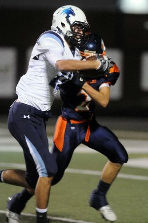 STAFF PHOTO ANTHONY REYES -- Springdale Har-Ber senior receiver Michael Fine (11) fends off Rogers Heritage senior Daniel Spickes (2) for a 50-yard touchdown in the first half Friday Oct. 14, 2011 at Gates Stadium in Rogers. Visit http://photos.nwaonline.com/ to see more photos.