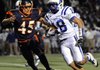 Stokes Wenzler, right, Rogers High running back, is chased down by Rogers Heritage linebacker Branden Uhrig on a carry during the first half of the Sept. 30 game in Gates Stadium in Rogers.
