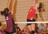 Farmington’s Rene Scheyder, right, jumps to spike a ball against Gentry in the 4A-1 District Volleyball Tournament in Gravette on Monday.