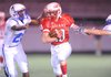 Garrett Wuehler of Fayetteville Ramay carries the ball past Rogers High freshman defender Bryan Harrel, left, during a recent Northwest Arkansas Conference game at Harmon Field. The Indians host Rogers Heritage today at 7:30 p.m.